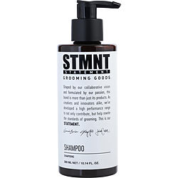 STMNT Grooming Goods Shampoo in a sleek black bottle with pump dispenser. The label emphasizes passion and innovation in its design.