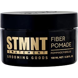 Black jar of STMNT Grooming Goods Fiber Pomade, prominently displaying the brand and product name in gold and white text. Designed for strong hold and natural finish in hair styling.