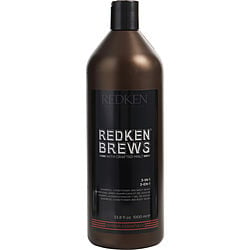 A bottle of Redken Brews 3-in-1, a versatile grooming product that serves as shampoo, conditioner, and body wash, featured in a sleek, dark brown container.